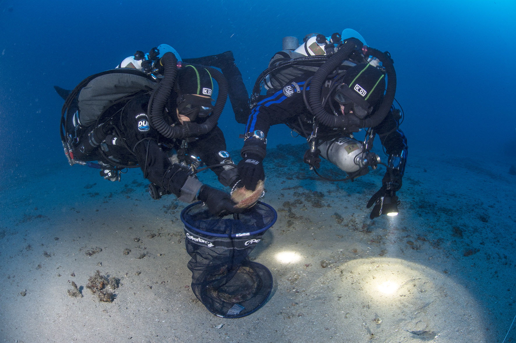Divers recover a bowl. Photo by Claudio Provenzani