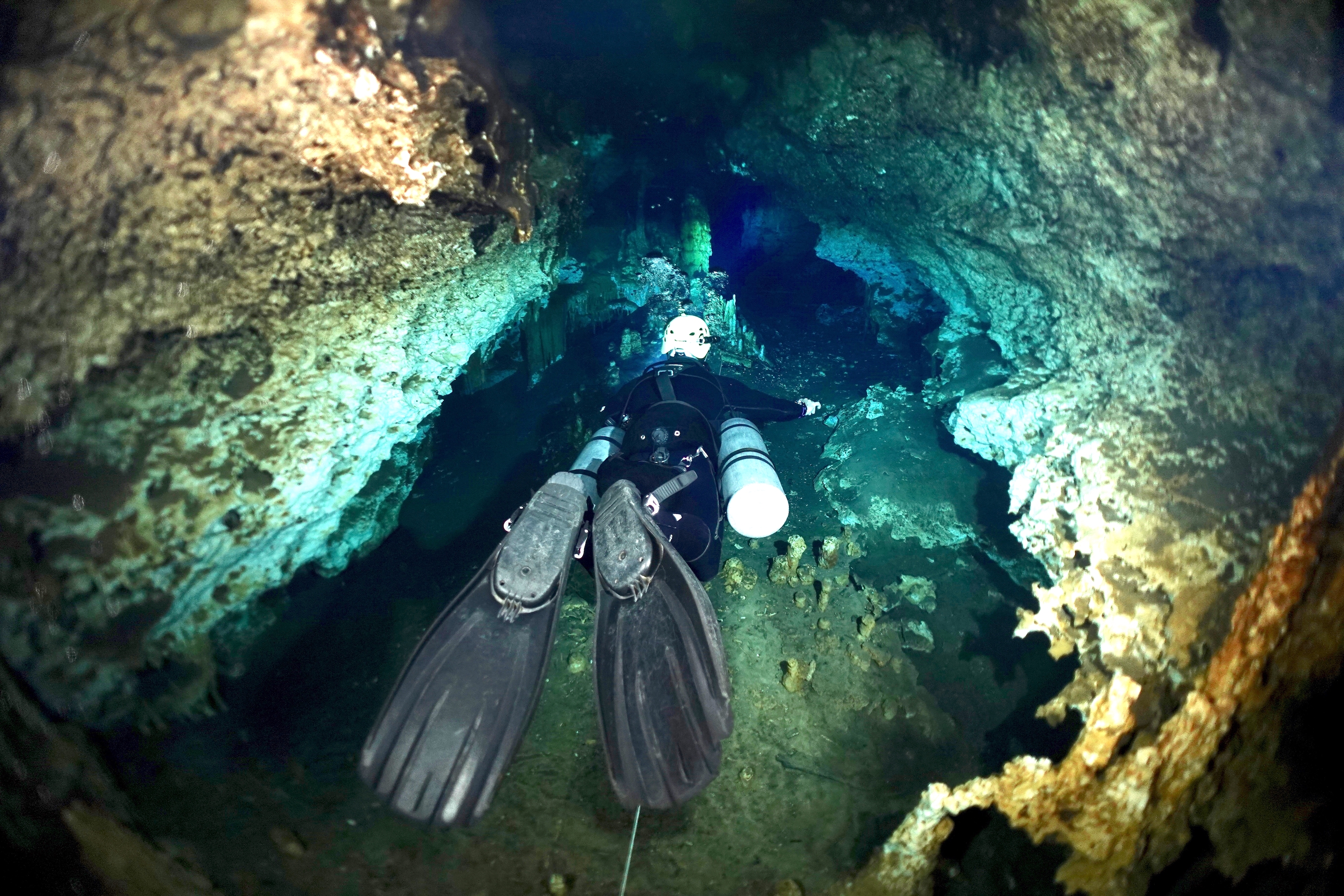 Dive guide Thibault inside tunnel of Cenote Cristal. Photo by Pierre Constant