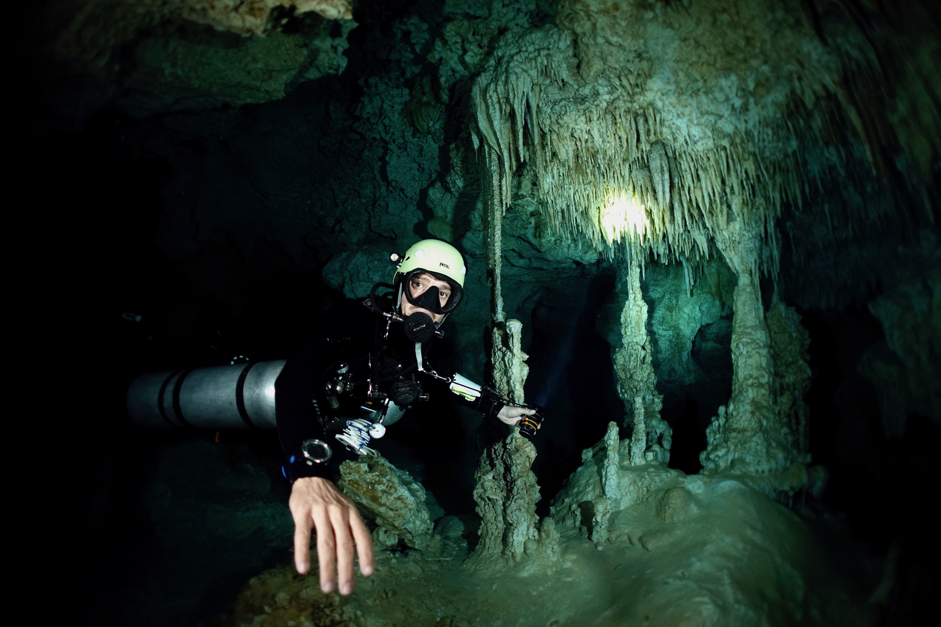 Diver and exquisite pillars in Cenote Chan Hol. Photo by Pierre Constant