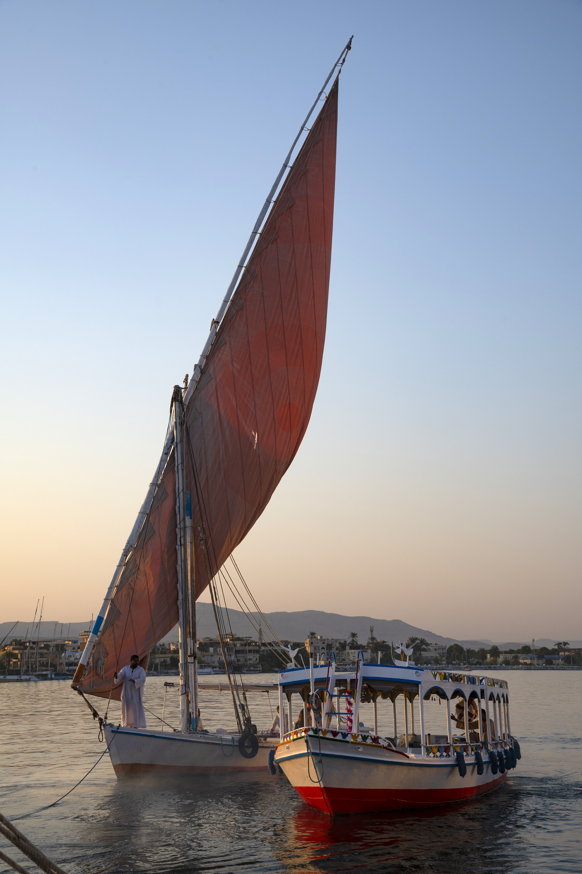 Felucca sailboat and cruise boat on the Nile at Luxor. Photo by Scott Bennett