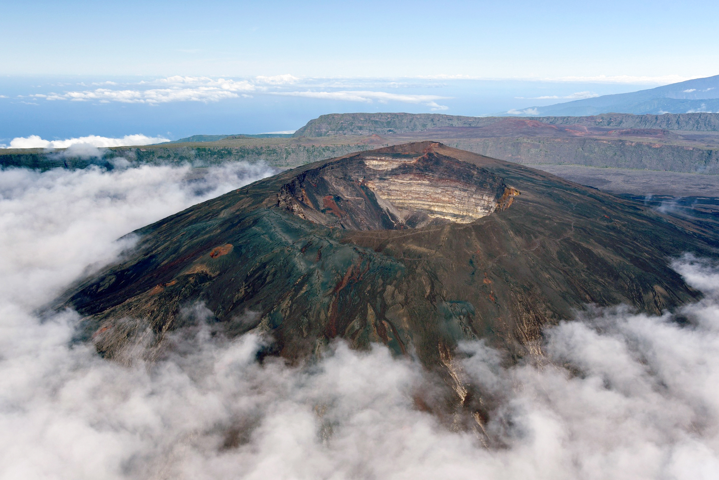 Piton de la Fournaise volcano, looms above the clouds