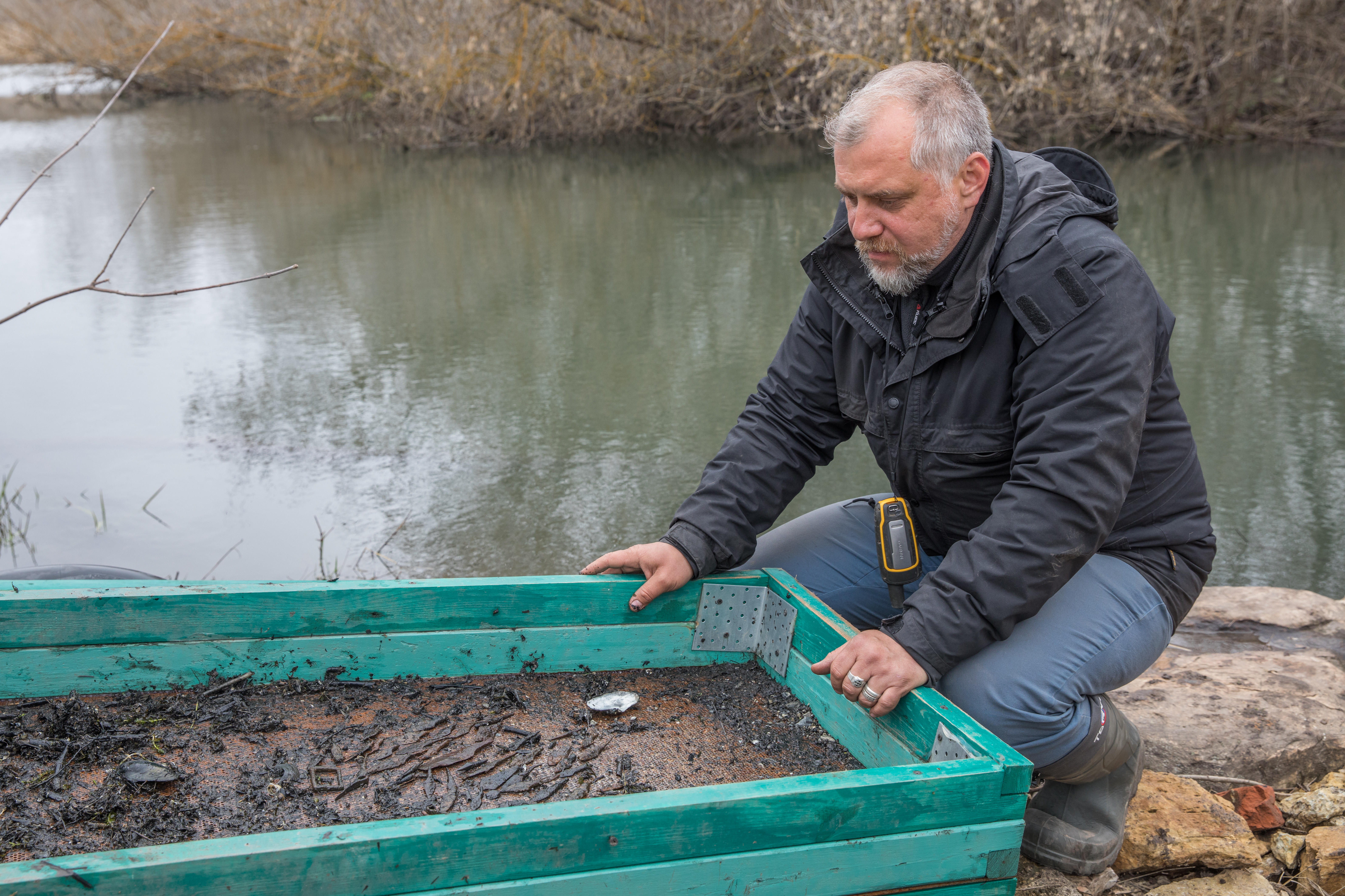 Oleg Radyush is surprised by the findings from the bottom of the river. Photo by Stanislav Trofimov
