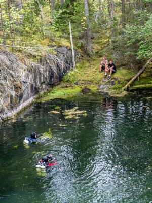 Divers enter the surface waters over one of the mines on Utö Island, under the watchful eye of surface-support members of the expedition.