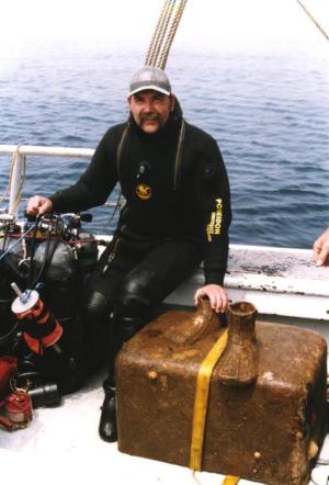 Moyer, after a dive on the Andrea Doria, posing with the bronze base of Admiral Doria’s statue salvaged from the wreck