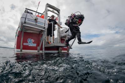 Diver jumps off the lift on the back of the dive boat