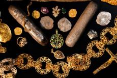 Numerous priceless artifacts including: solid gold and silver coins, jewelry, uncut gemstones and silver bars weighing over 70 pounds have been recovered so far.