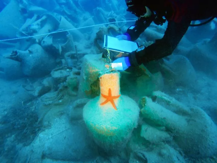 Underwater archaeologist working on a site of amphorae on the shipwreck of the Mazotos, in Cyprus
