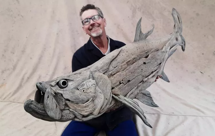 The artist, Tony Fredriksson, with his driftwood sculpture Tarpon