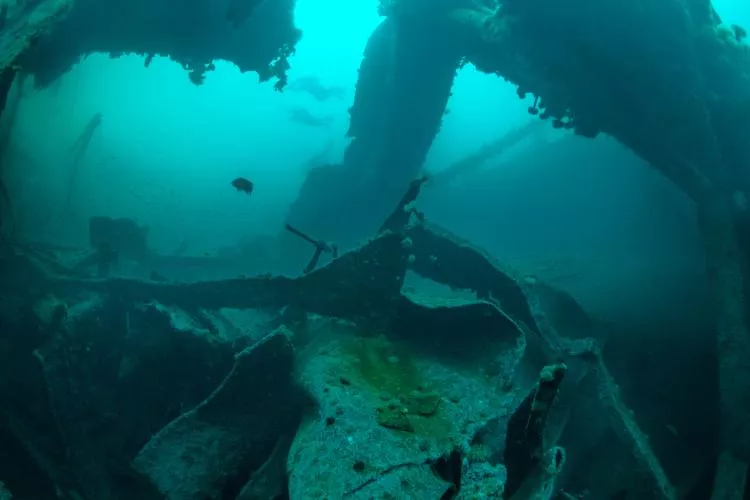 Divers swim over the massive damage done at midships on PLM-27 during WWII. Photo by Brandi Mueller
